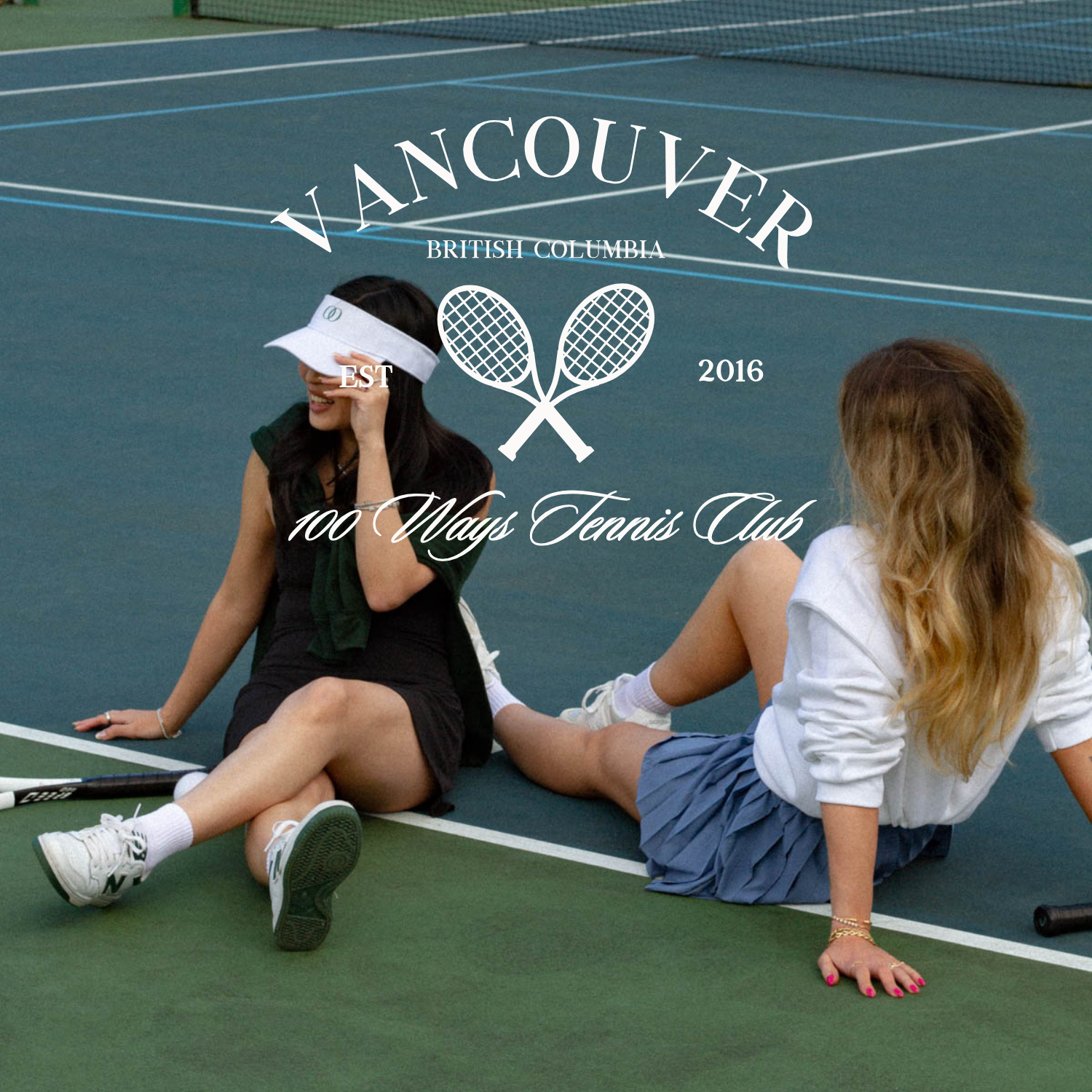 Image of two women sitting casually on the tennis court. Text reads: Vancouver, British Columbia. Est. 2016. 100 Ways Tennis Club