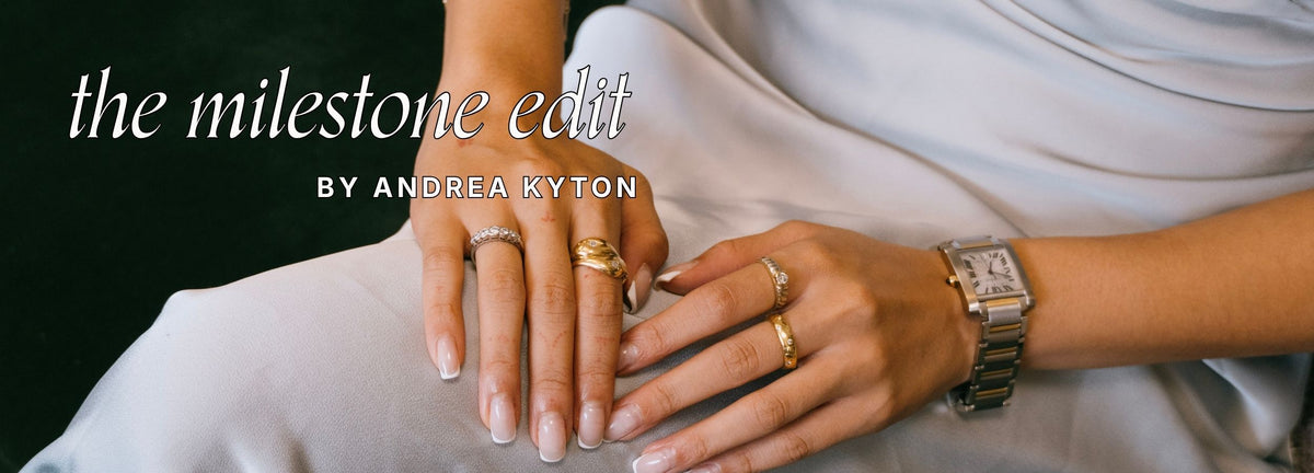 A close-up lifestyle shot of a person's hands resting on their lap, showcasing preloved, vintage gold diamonds rings, a two-tone Cartier watch. Text reads: The Milestone Edit by Andrea Kyton