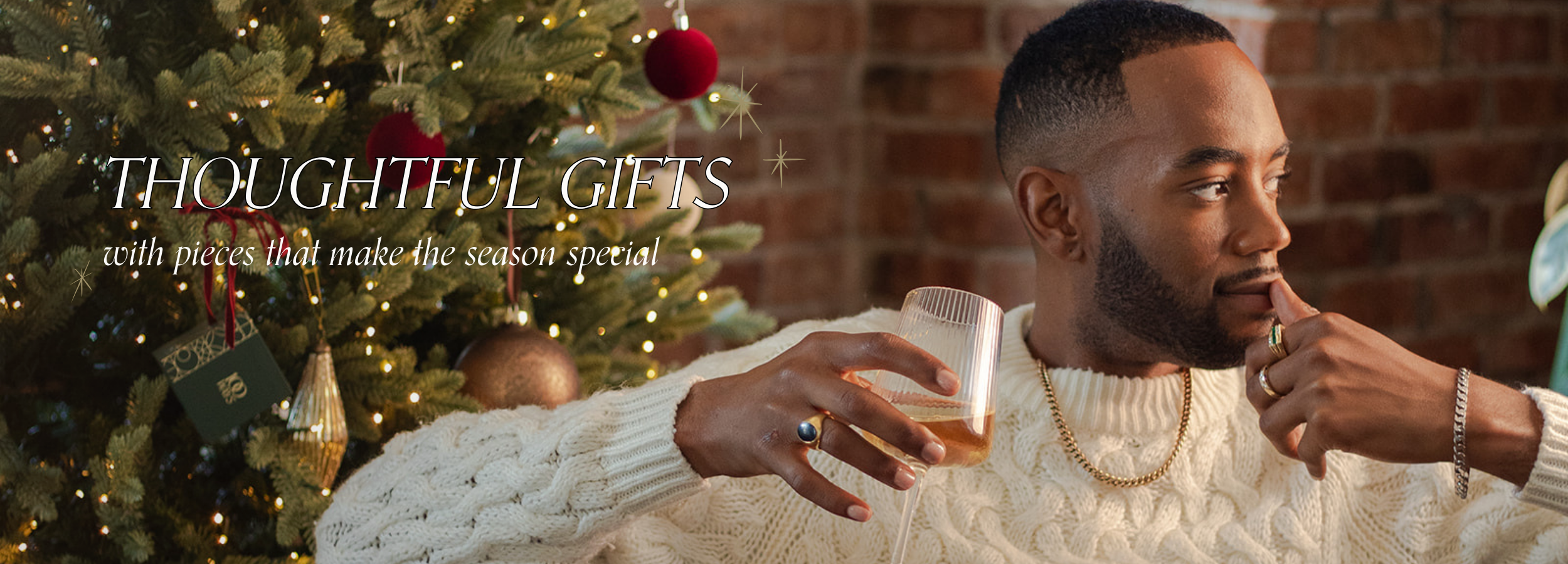 Thoughtful holiday gifts featuring vintage and preloved fine jewellery, styled on a model beside a decorated Christmas tree.