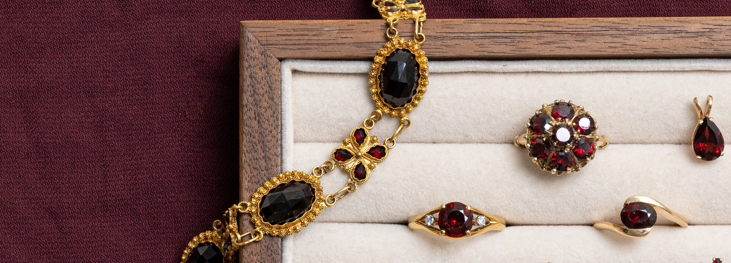 January garnet birthstone jewellery featuring vintage and preloved gold rings, earrings, and bracelet.