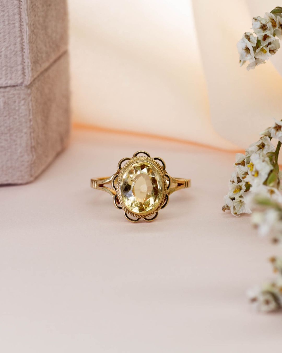 citrine ring against pale pink background