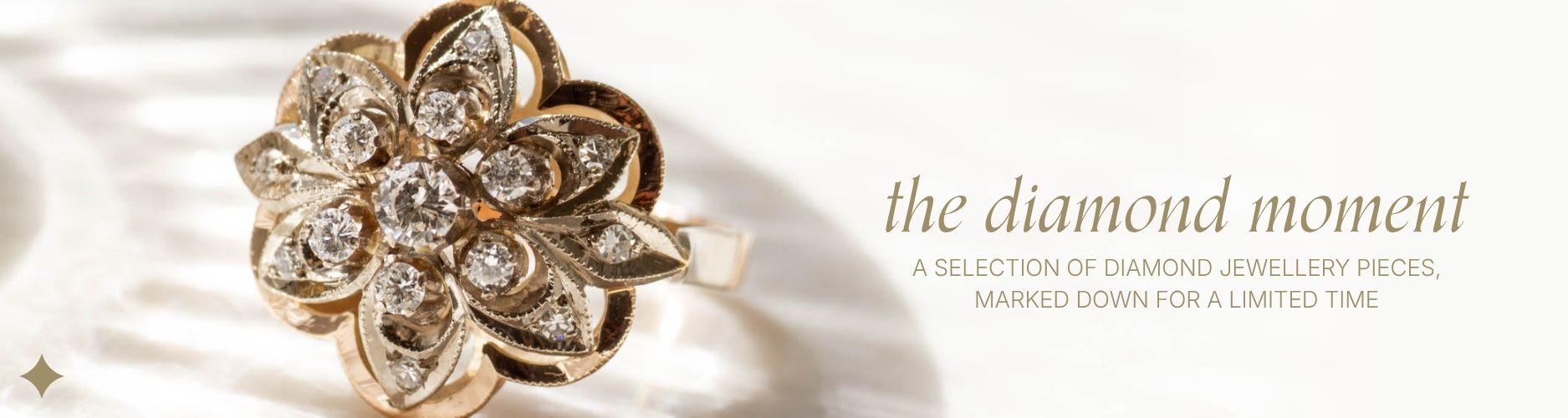 close up image of diamond ring in yellow gold floral setting, on shadowy white background with text overlay that reads 'the diamond moment; a selection of diamond jewellery pieces marked down for a limited time'