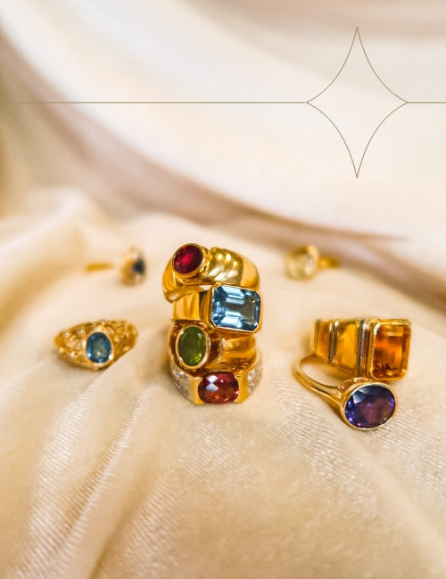 image of stacked bold gemstone rings from the 100 ways colourburst collection on a tan velvet surface with starburst line art overlay