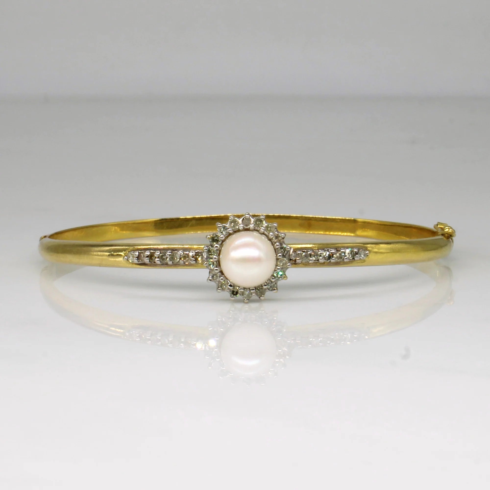 close up product shot of a pearl and diamond bangle braclet