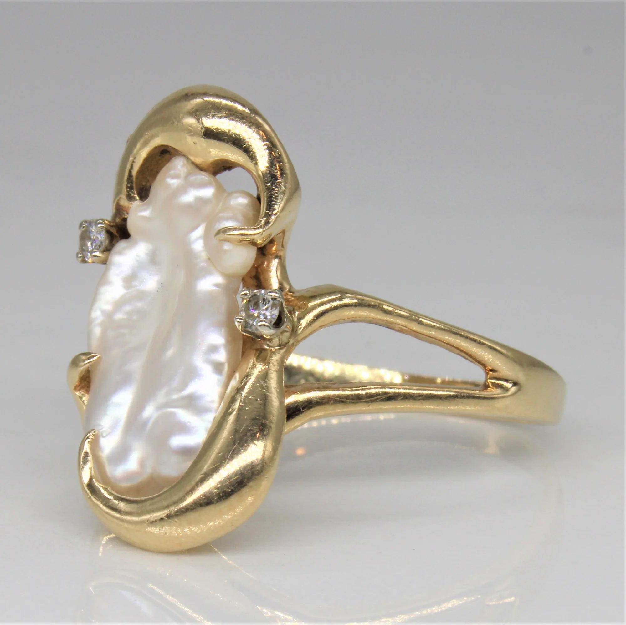 close up product image of cultured pearl ring with diamonds and yellow gold