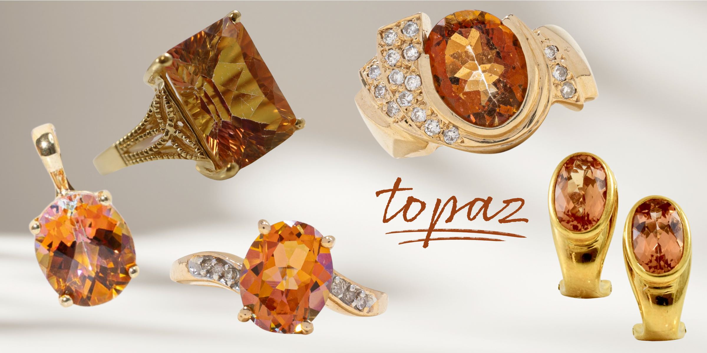 image of topaz and yellow gold jewellery on a soft background