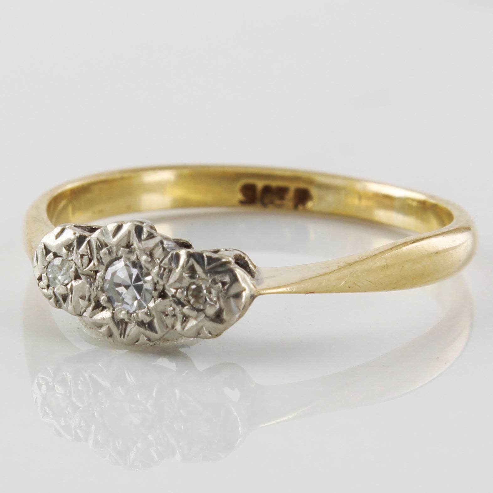 vintage three diamond set ring with gold band,